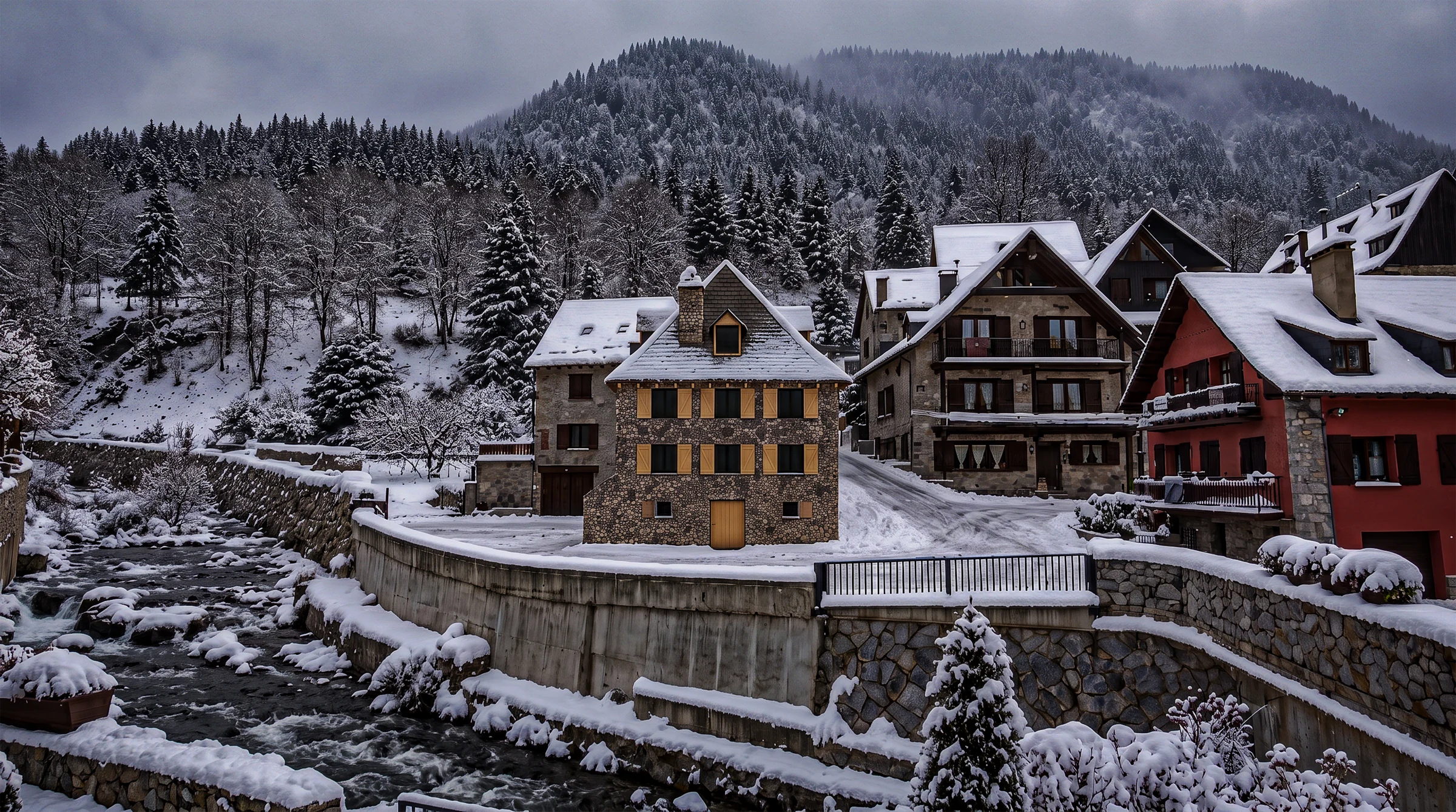 Stone house beside a river with snow-covered slate roofs and mountain trees